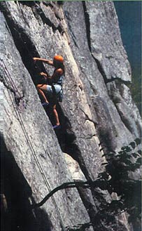 A female rock climber ascends a crag in the White Mountains